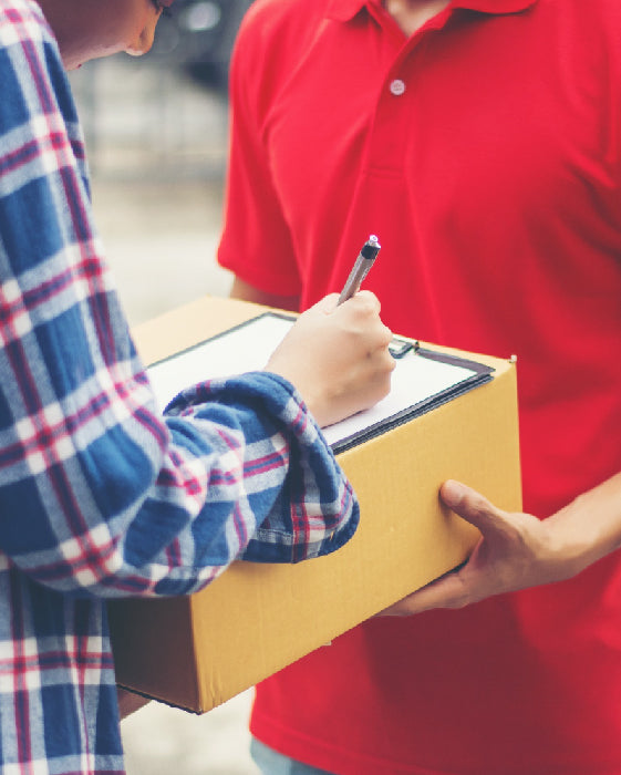 women taking delivery of product from delivery-man