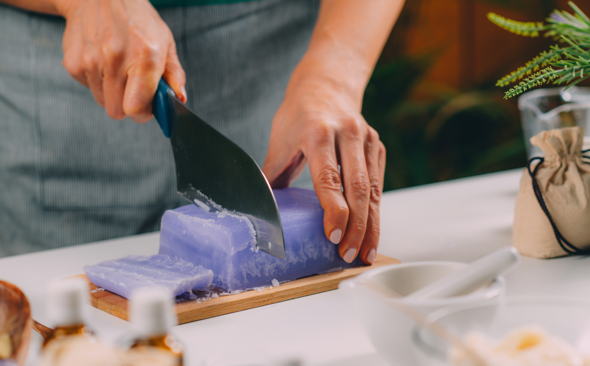 woman cutting soap base